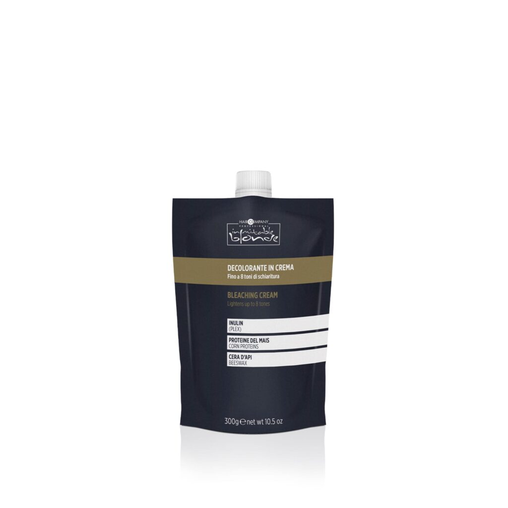 Hair Company UK The black, soft, stand-up pouch with a screw cap at the top contains decolorizing cream. The front label showcases text in English and Italian, detailed with white and gold print. The pouch holds 300 grams (10.5 oz) of product, designed for easy application.