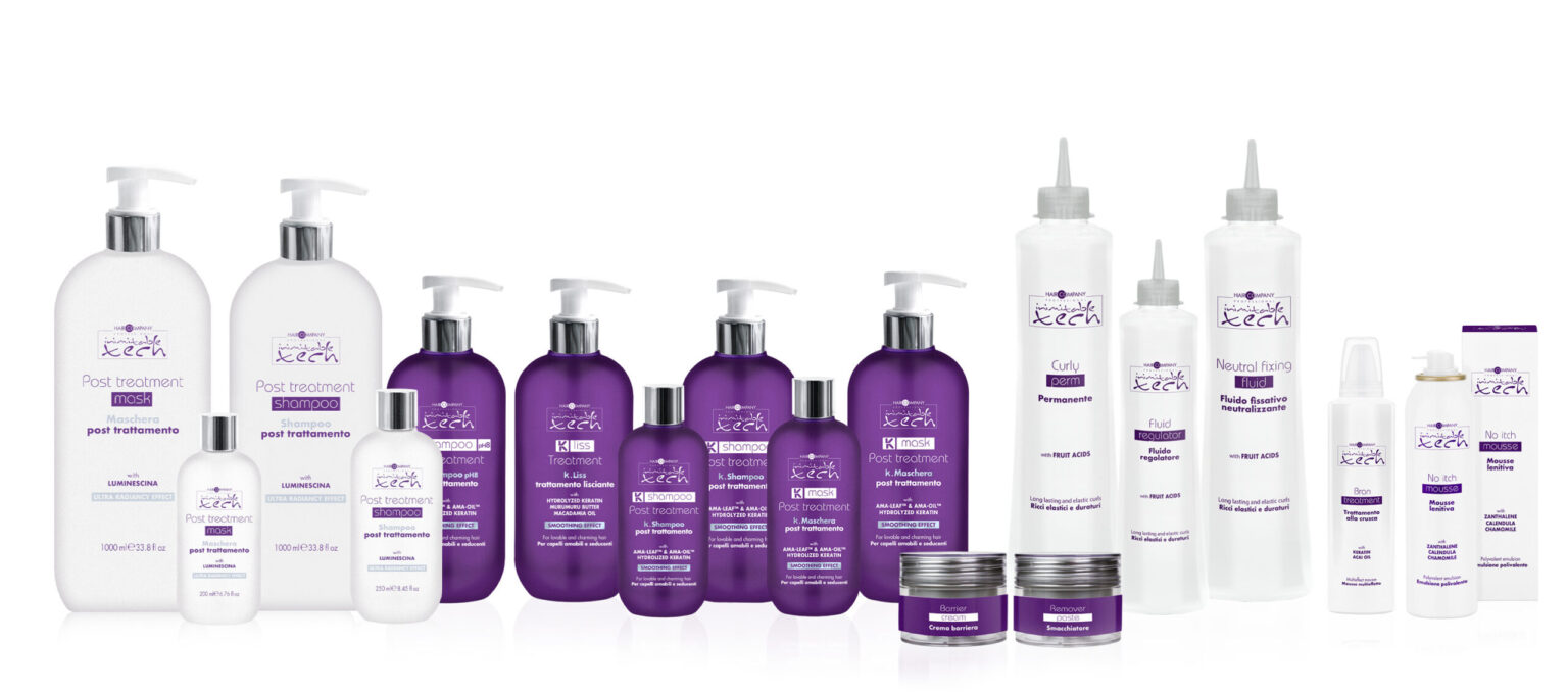 A lineup of hair care products with purple and white packaging set against a white background. The collection, featuring Inimitable Tech, includes various bottles labeled "Post Treatment," along with jars, spray bottles, and tubes—all from a single brand.