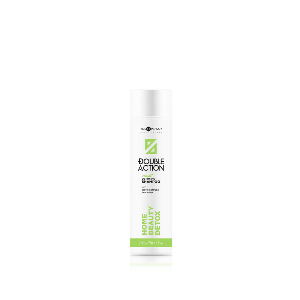 Hair Company UK A bottle of "Detoxing shampoo 250ml" from Hair Company Professional, adorned with green accents and labeled for a "Home Beauty Detox," stands against a plain background. This 250 ml (8.45 fl oz) white bottle promises rejuvenated hair and a refreshing detox experience.